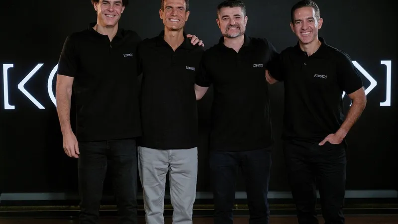 Four men in black polo shirts standing together before a black backdrop.