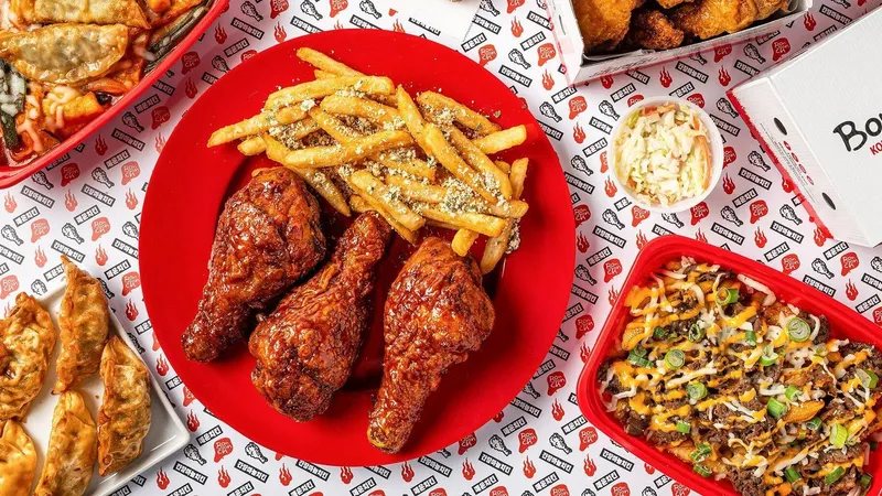 Fried chicken, seasoned fries, dumplings, coleslaw and loaded fries on a branded tablecloth