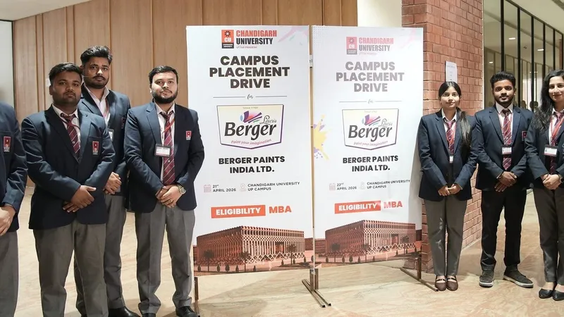 Students in formal attire stand beside Chandigarh University Berger Paints campus placement drive banners.