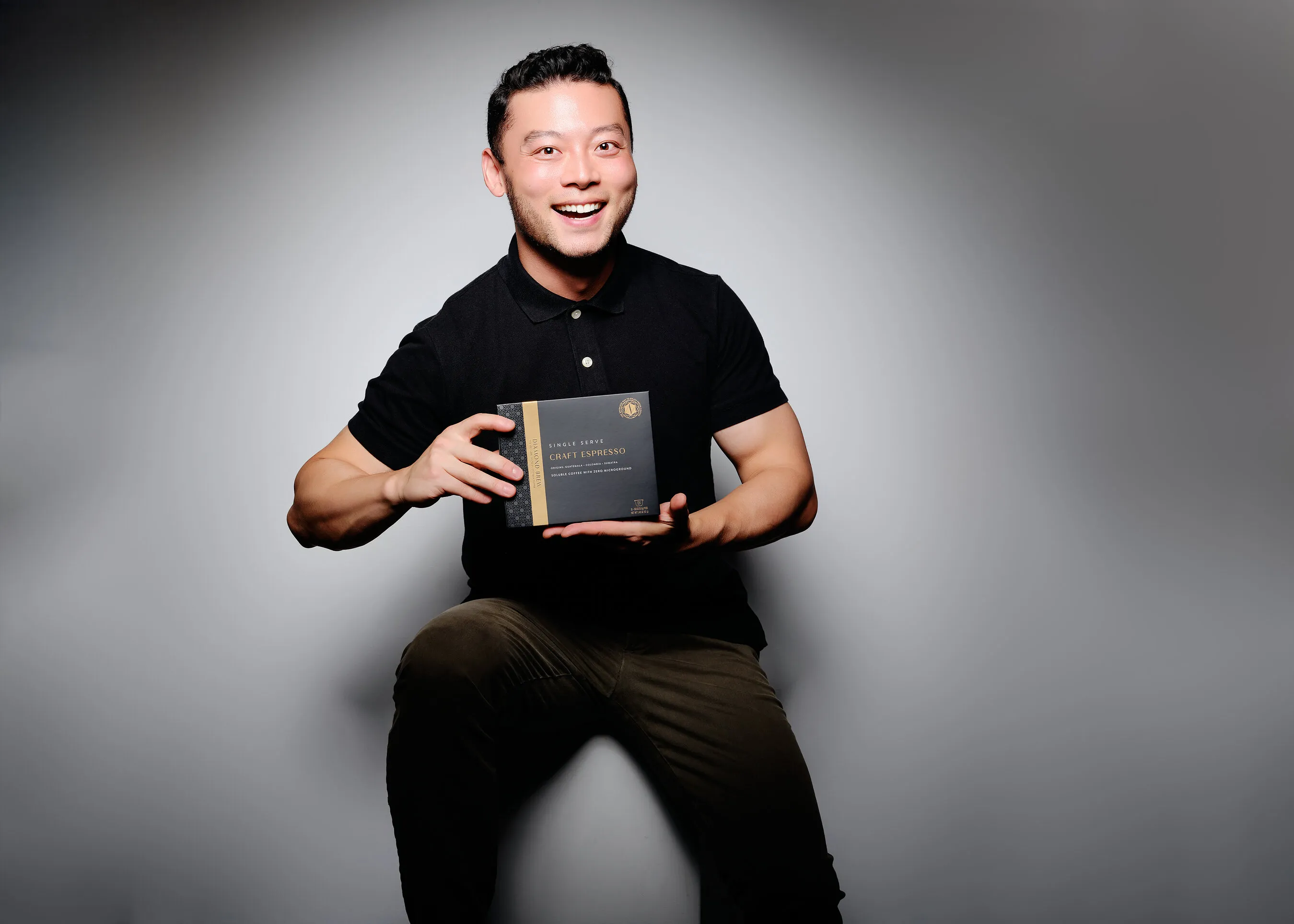 Douglas Yu holds a box of Diamond Brew Coffee craft espresso.