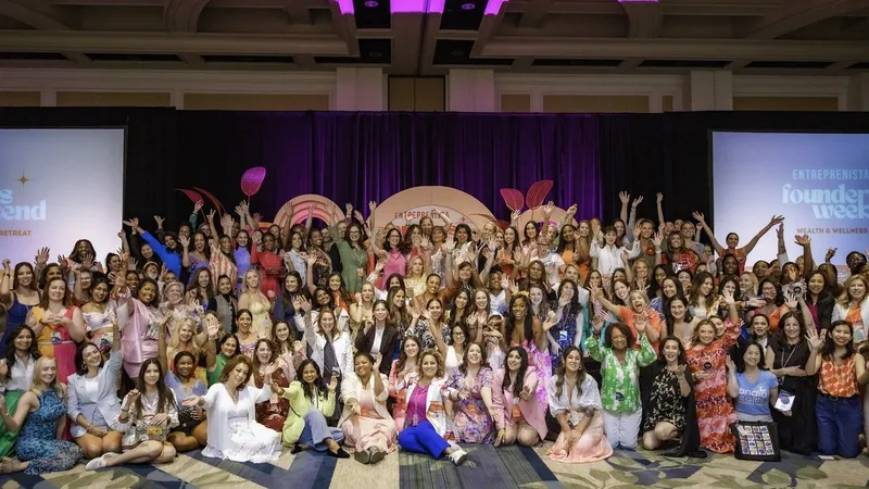Large group of women waving onstage at the Founders Weekend retreat.