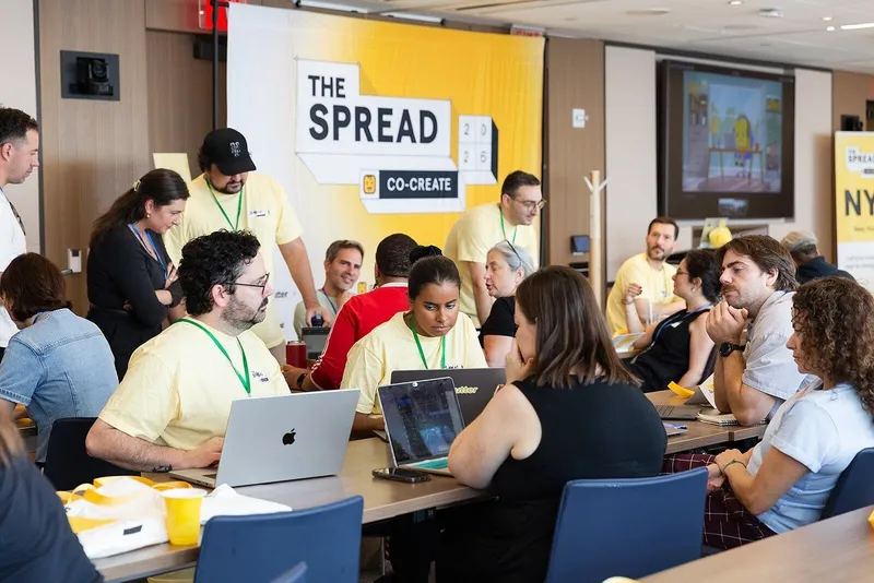 People collaborating at tables during a Givebutter nonprofit event.