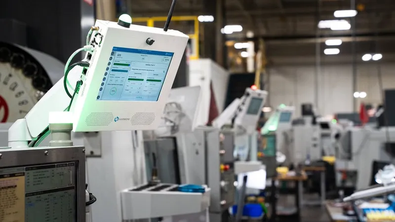 Industrial machines with touchscreen control panels in a factory.