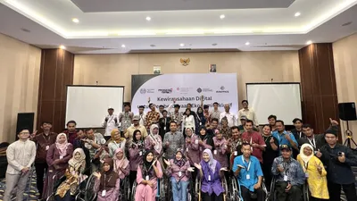 Group of attendees, including wheelchair users, posing at a digital accessibility event.