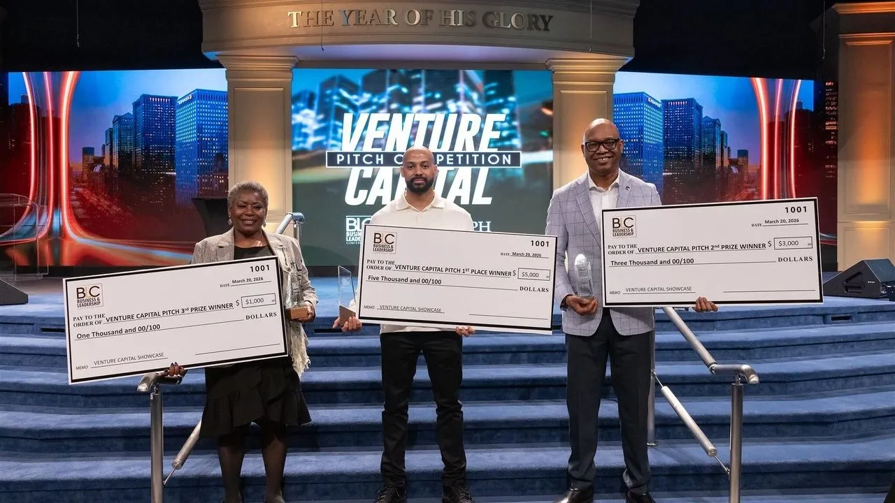 Three winners hold oversized prize checks and trophies on a stage.