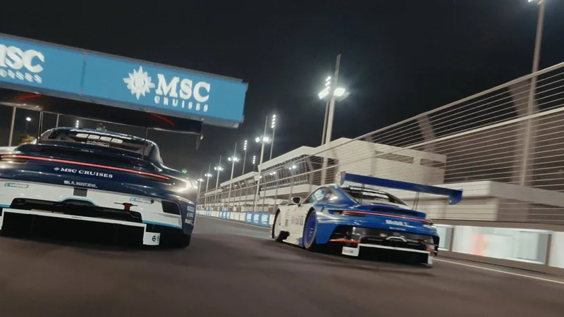 Two blue-and-white Porsche 911 GT3 R race cars on a floodlit circuit at night.