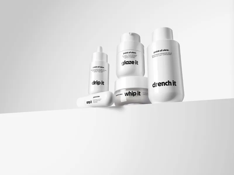 Five white Point of View skincare bottles and jars arranged on a white surface.
