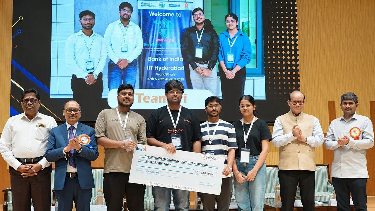 Students hold a ceremonial cheque with officials at the CyberGenius Hackathon awards ceremony.