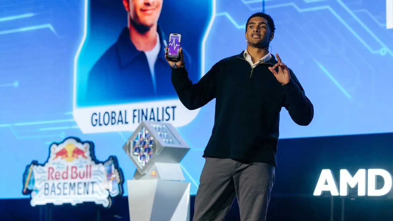 Darnell Adler presents a smartphone onstage at the Red Bull Basement World Final.