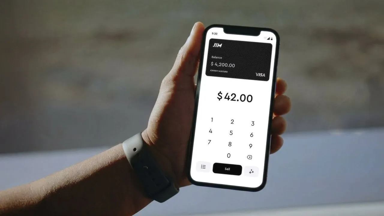 Hand holding a smartphone displaying a payment app with a $42.00 sale amount