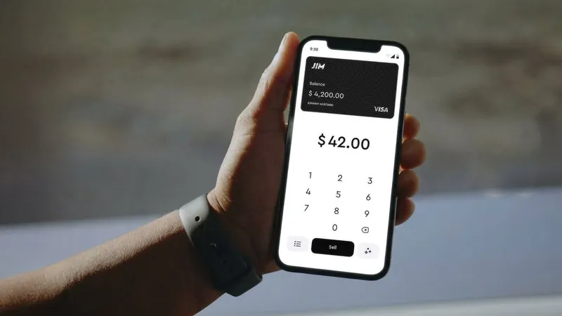 Hand holding a smartphone displaying a payment app with a $42.00 sale amount