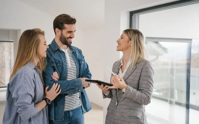 An estate agent showing a couple around a home