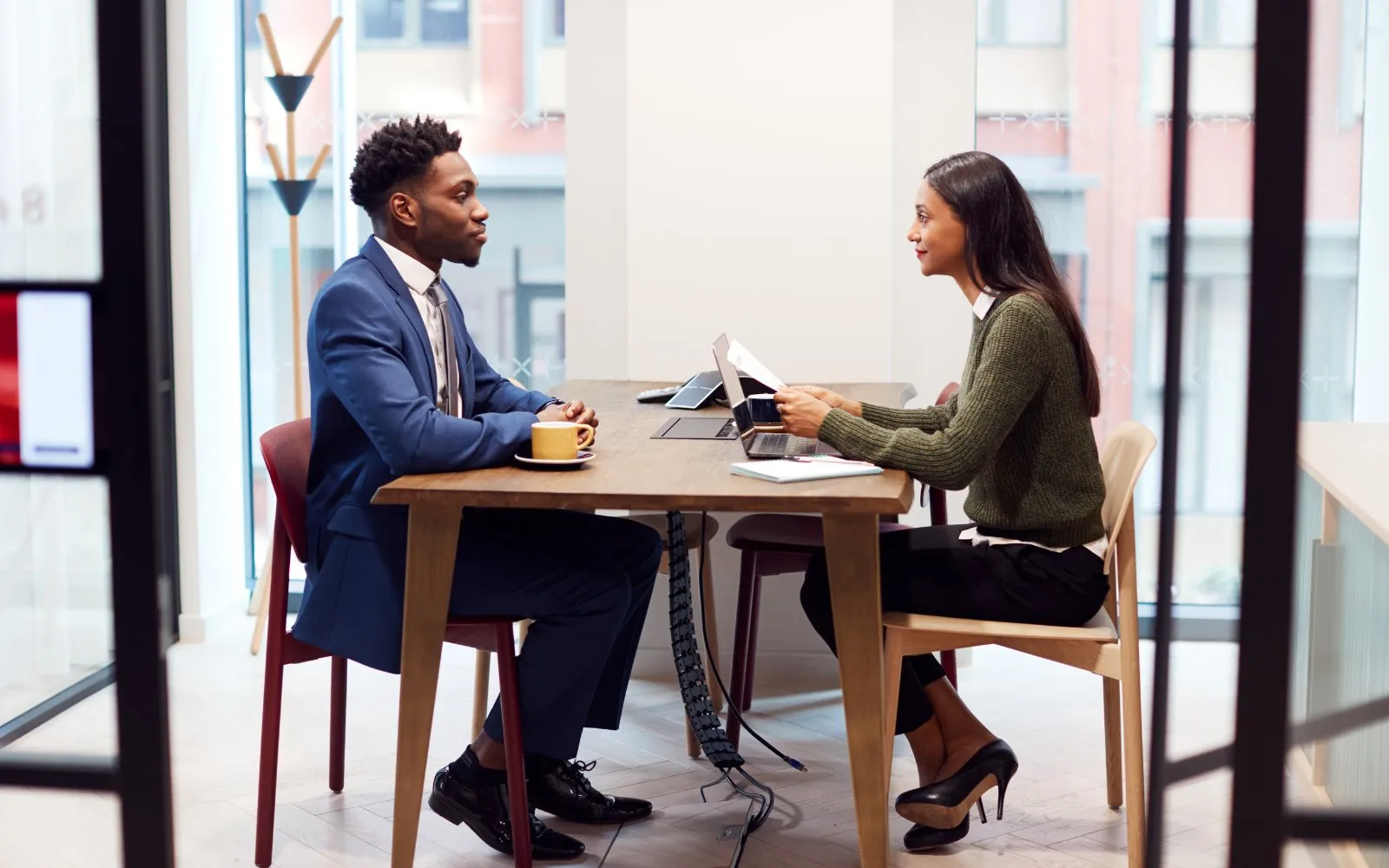 A job interview across a small table in a bright office