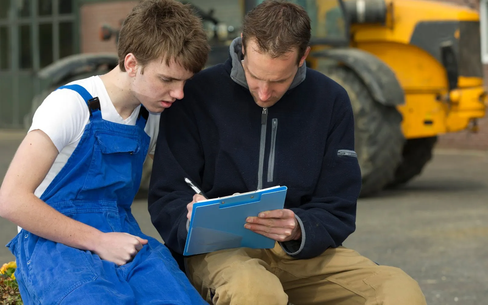 An apprentice going through a checklist with his mentor
