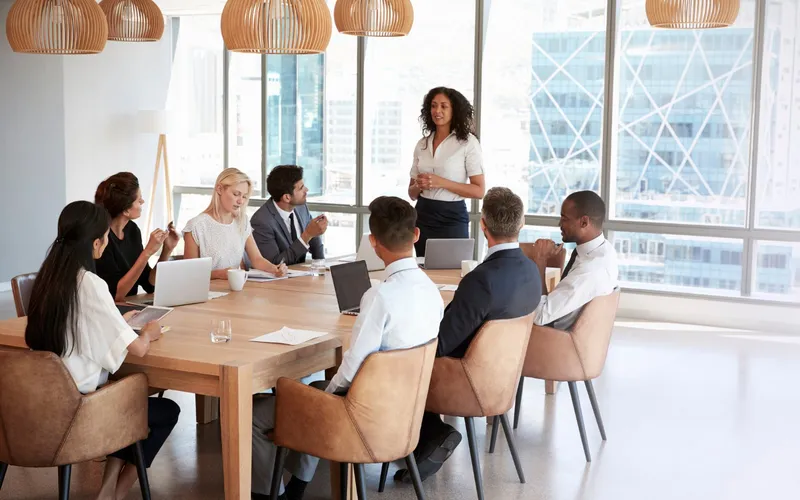 A small team meeting around a long table in an office
