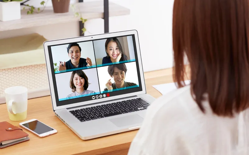 A woman on a video call with four colleagues on her laptop