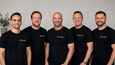 Five people wearing black T-shirts with white Avalon logos stand together.