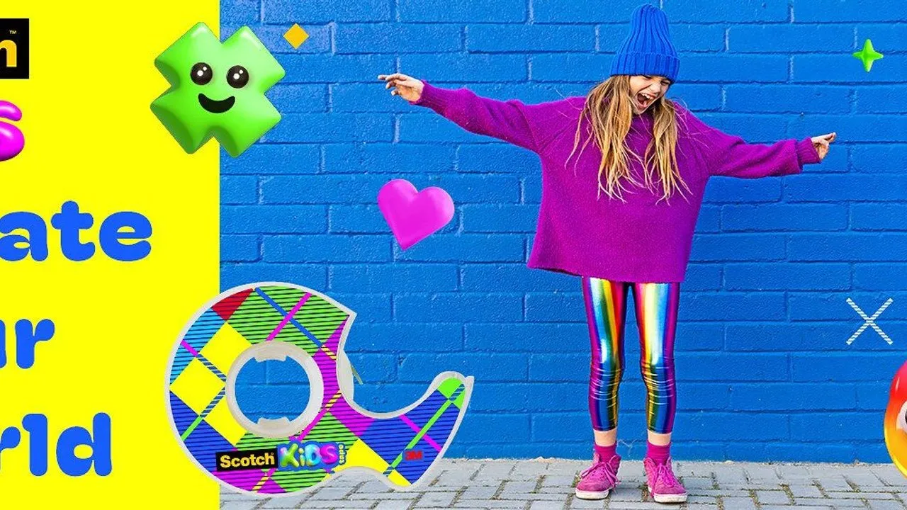 Girl in a purple sweater and rainbow leggings beside a giant Scotch Kids tape dispenser against a blue brick wall